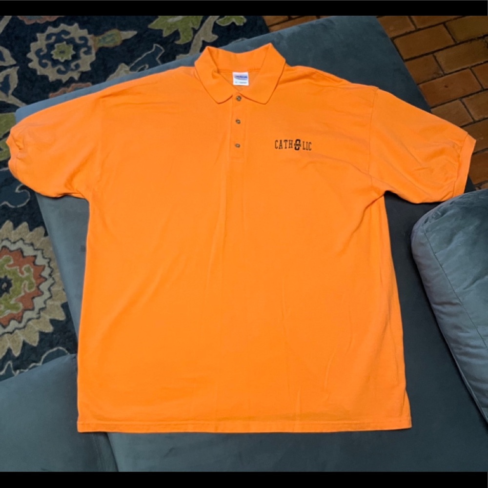 EUC Oklahoma State University Catholic polo shirt.